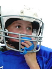 Child in Football Helmet with Mouth Guard at the Pediatric Dentist Office in Casa Grande, Mesa and Chandler, AZ